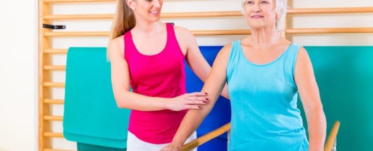 A senior woman participates in physical rehab after suffering a stroke.