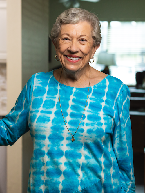 a concrodia resident smiling and posing in front of her room