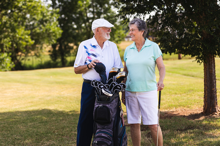 senior couple playing golf together