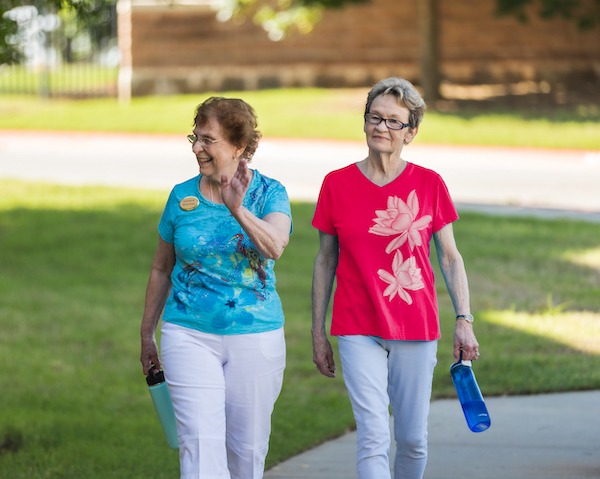 two women walking together outside