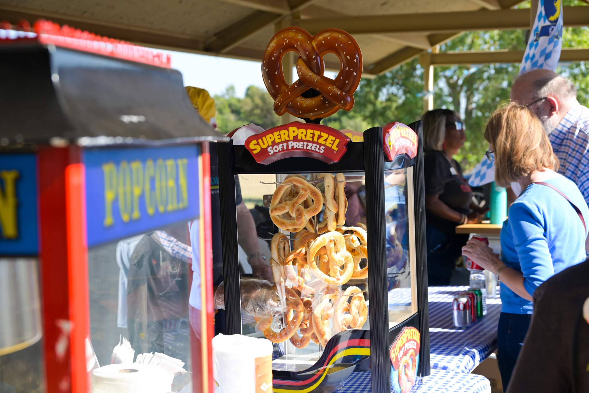 a popcorn machine and soft pretzel warmer on a table