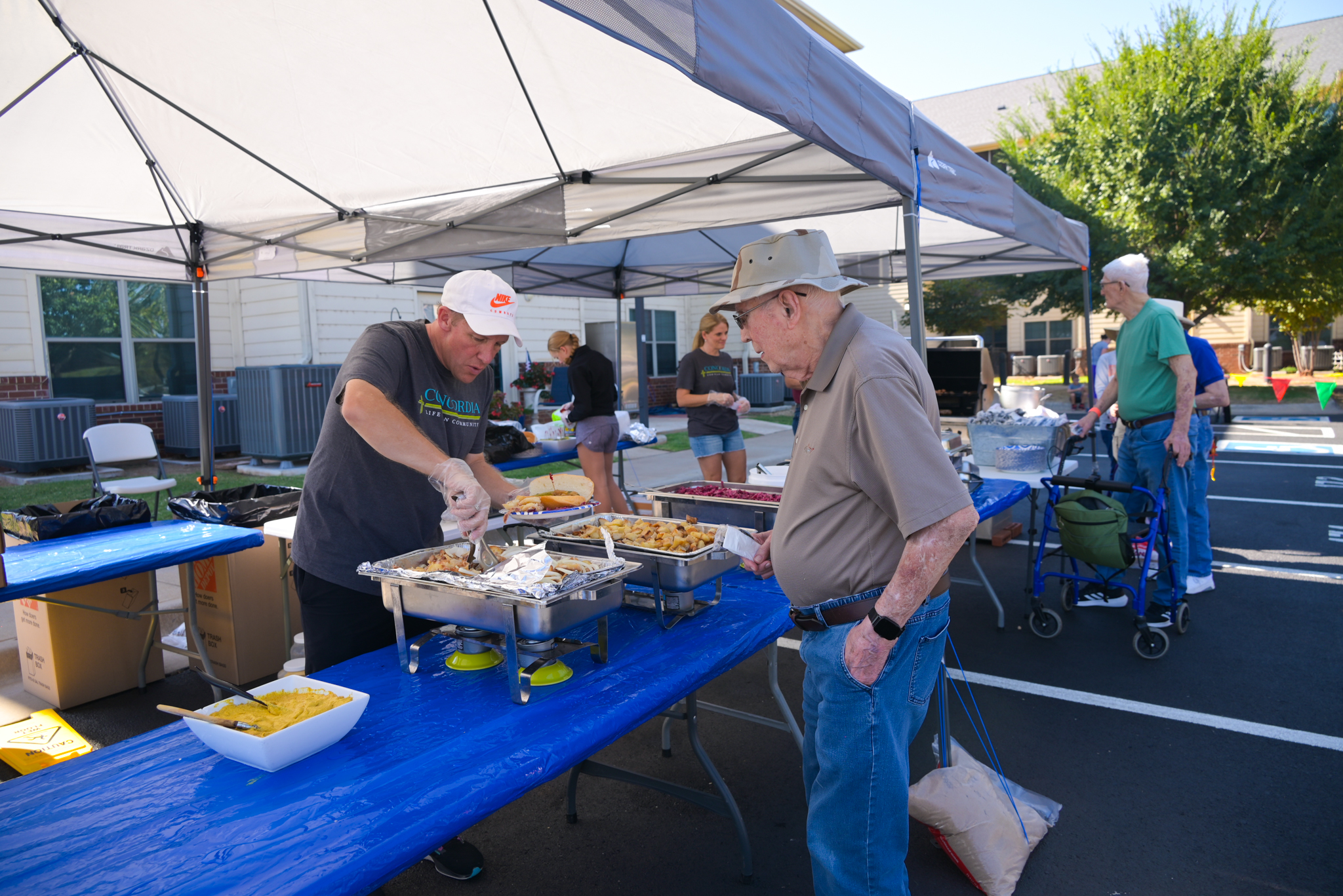 a concordia employee serving food to a concordia resident